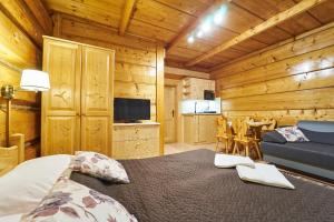 a bedroom with a bed in a wooden cabin at Noclegi u Hanki in Bukowina Tatrzańska