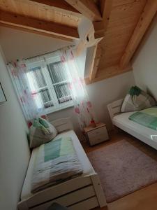 a small room with two beds and a window at Ferienwohnung Christine in Altaussee