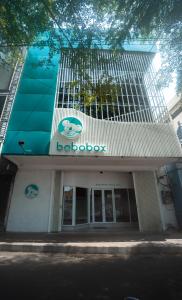 a building with a sign on the front of it at Bobopod Slamet Riyadi, Solo in Solo