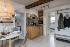 a kitchen and dining room with a table and chairs at FOREST & MOUNTAIN - 2min Bikepark, SNES, SSC, Bikegarage, Terrace in Winterberg