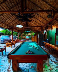 a pool table in a restaurant with a pool at Hotel Borari in Alter do Chao