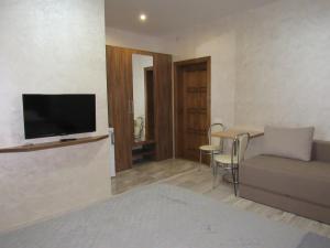 a living room with a couch and a table at Solomiia in Solochyn