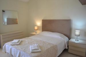 a bedroom with a bed with two towels on it at Marina Plaza by Garvetur in Vilamoura