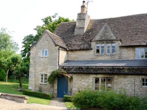 an old stone house with a blue door at Rectory Farm Annexe in Counthorpe
