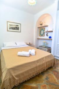 a bedroom with a bed with two towels on it at Panoramic Sea View Villa Saint Anna in Kalo Livadi