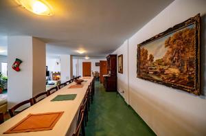 a dining room with a large painting on the wall at Belvedere Chalet Bran in Bran