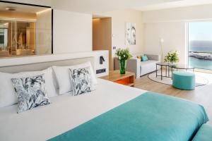 a bedroom with a bed and a living room at Arrecife Gran Hotel & Spa in Arrecife