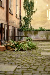 a bench sitting on a brick sidewalk next to a building at Light and spacious Apartment on Gazova Str in Lviv