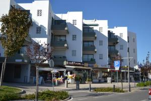 a white building with a street in front of it at Algamar by Garvetur in Vilamoura