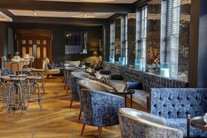 a restaurant with chairs and tables and a bar at Manor Hotel Solihull, BW Signature Collection in Bickenhill +32 photos