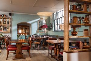a restaurant with tables and chairs in a room at Royal Seven Stars Hotel in Totnes