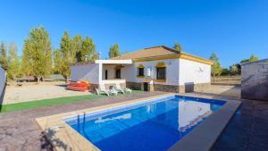 a villa with a swimming pool in front of a house at Casa San Nicolas Algar by Ruralidays in Algar