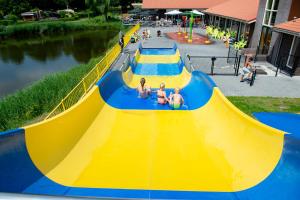 a yellow and blue slide with three people on it at Camping de Vogel in Hengstdijk +36 photos