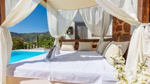 a bedroom with a bed and a swimming pool at Villa Las Palmeras Torrox by Ruralidays in Torrox