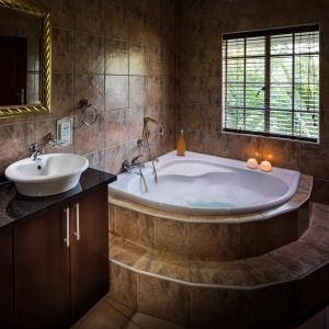 a large bathroom with a tub and a sink at Gallo Manor Executive Bed & Breakfast in Johannesburg