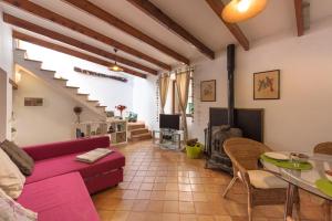 a living room with a red couch and a table at Macarena's House in Valldemossa