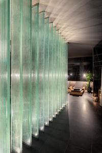 a hallway with glass dividers in a room at Lure Hotel & Spa - Adults Only in Mellieħa