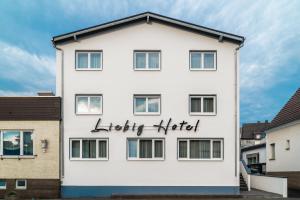 a white building with the words lefty kitchen written on it at Liebig Hotel in Ehringshausen