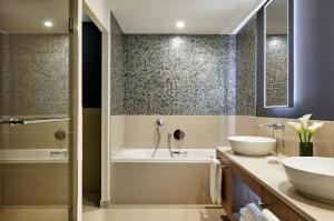a bathroom with two sinks and a tub and a shower at InterContinental Lyon - Hotel Dieu by IHG in Lyon +139 photos