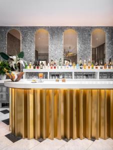 a bar with a gold and white counter at Lure Hotel & Spa - Adults Only in Mellieħa