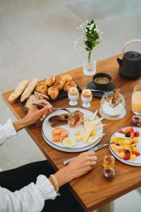 a table topped with plates of food and bread at InterContinental Lyon - Hotel Dieu by IHG in Lyon +124 photos