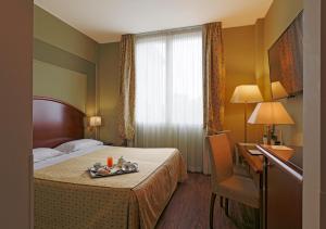 سرير أو أسرّة في غرفة في فندق سافويا ريجنسي