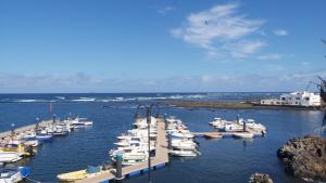 a bunch of boats are docked in the water at APARTAMENTO ALEGRANZA in Orzola