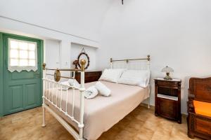 A bed or beds in a room at Authentic Santorinian Home Experience