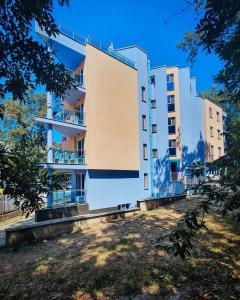 a large white building with trees in front of it at Hotel Park 2 in Kiten