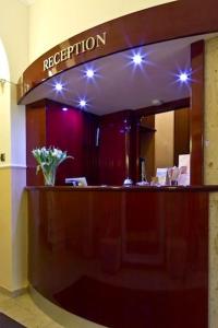 a reception desk in a building with a mirror at Buchholz Downtown Hotel in Cologne