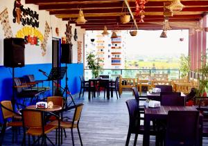 a restaurant with tables and chairs and a balcony at Luna Mare Resort Mersin in Mersin