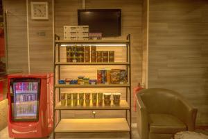 a refrigerator and a chair in a room at Hotel Villa in Seremban