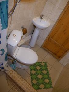 a bathroom with a toilet and a sink at Belovodye Hotel in Kamennomostskiy