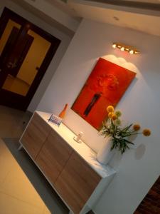 a bathroom with a sink and a painting on the wall at Appartement F4 Meublé Liberté 6 Extension in Dakar
