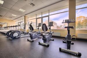 a gym with treadmills and elliptical machines at Beshtau Hotel in Pyatigorsk