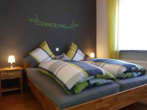 a bedroom with two beds with pillows and a window at Ferienwohnung Ellen in Ehrenberg