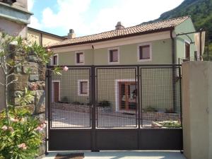 a gate in front of a house at Camere B81 di Strain Neva in San Dorligo della Valle