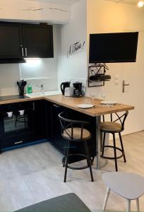 a kitchen with a table with two chairs and a tv at Studio centre ville -001 in Rouen