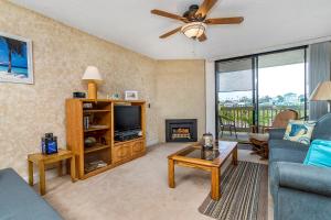 a living room with a couch and a tv at Condo in Beachfront Resort B-212 in Oceanside