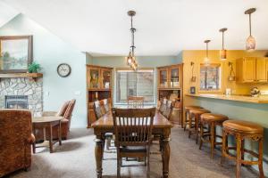 a kitchen and dining room with a table and chairs at Mountainside 612 in Thompsonville
