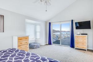 a bedroom with a bed and a large window at Seaside Strolls in Cayucos