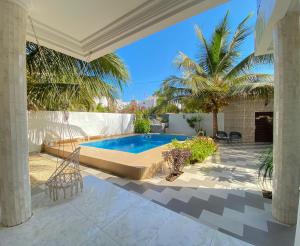a swimming pool in the middle of a house at Francesca Guest House in Dakar