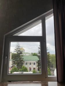 an open window with a view of a building at Apelsin apartment in Bila Tserkva