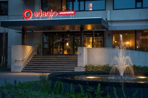 a building with a fountain in front of a building at Adagio Amsterdam City South in Amstelveen