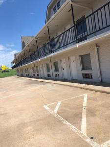 an empty parking lot in front of a building at BestWay Inn Oklahoma City Airport in Oklahoma City