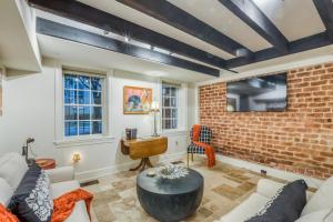 a living room with a brick wall at Garden Level on Charlton in Savannah