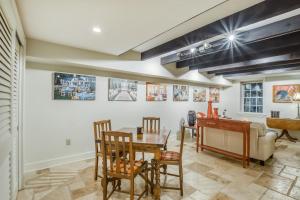 a living room with a table and a piano at Garden Level on Charlton in Savannah