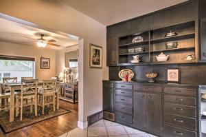 a kitchen and dining room with a dark wooden cabinet at Charming Downtown Coeur dAlene Home with Yard! in Coeur d'Alene