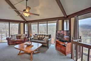 a living room with a ceiling fan and a tv at Beech Mountain Resort Home with Deck and Hot Tub! in Beech Mountain