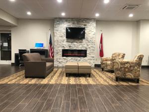 a lobby with couches and chairs and a fireplace at Quality Inn & Suites in Paragould
